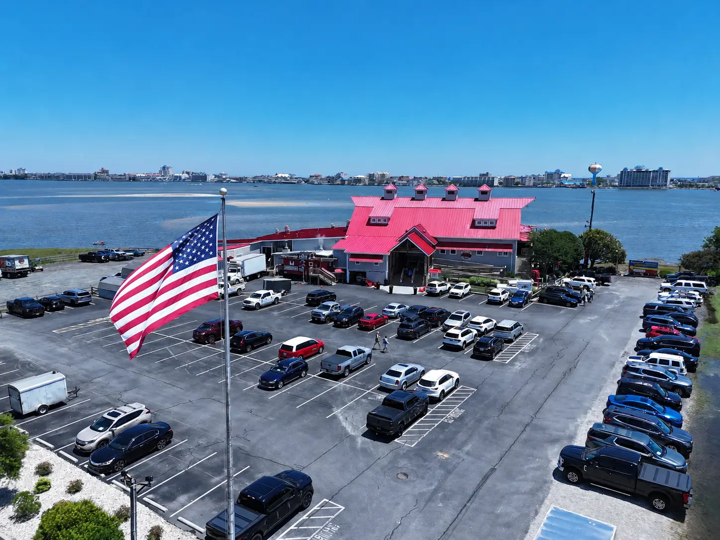 Aerial view of Hooper's Crab House with the American flag and bay views